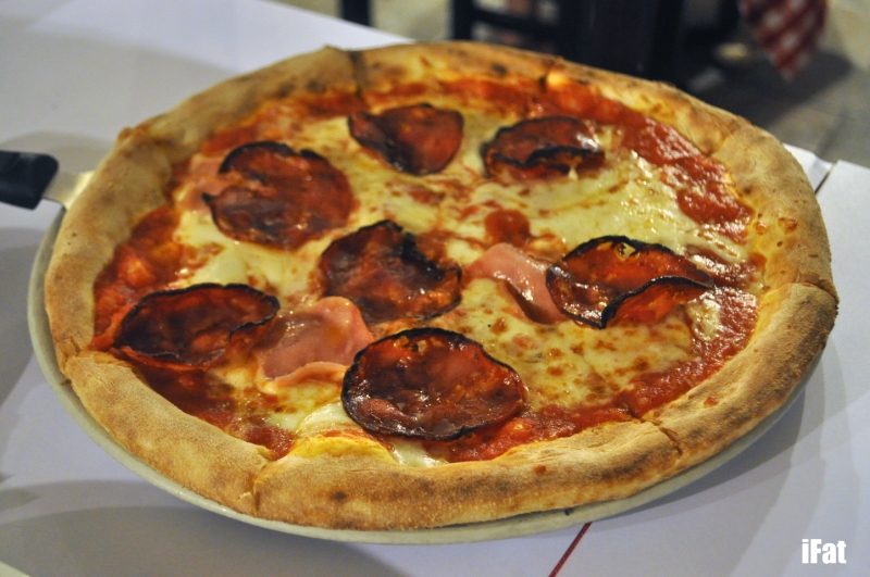 Scugnizzo pizza featuring tomato, mozarella, ham and spicy salami