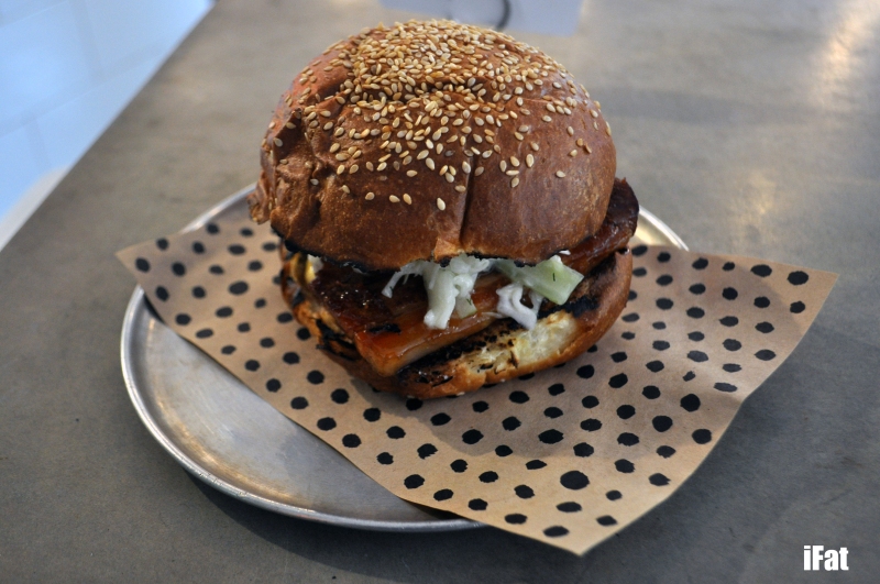 Twice cooked pork belly burger featuring chilli glaze, apple & celery slaw with aioli