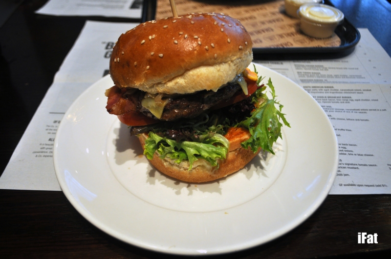 Mighty Charlie Burger featuring a wagyu patty with aged cheddar, Charlie & Co's signature tomato sauce, mixed leaf lettuce, tomato, caramelised onion, egg, bacon and aioli