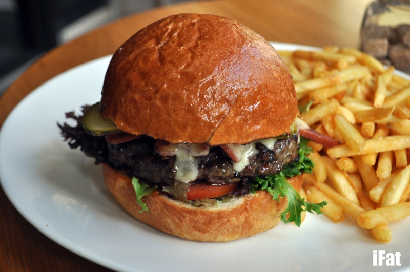 Wagyu beef burger with provolone cheese, smoked tomato relish, pickles - served with fries